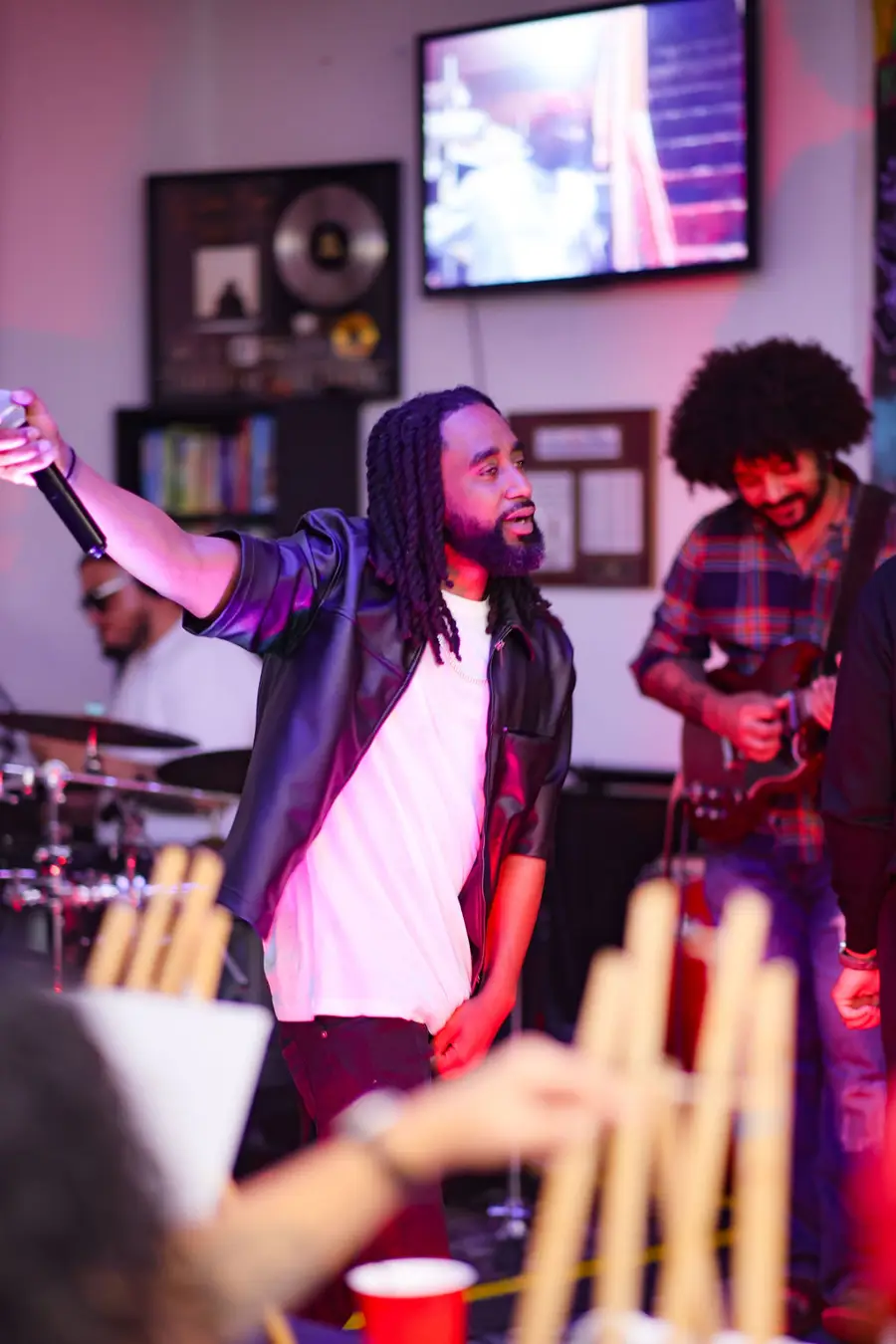 Vocalist and guitarist performing for the room