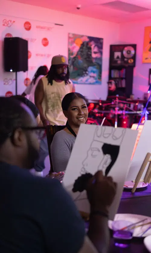Guest smiling at her canvas