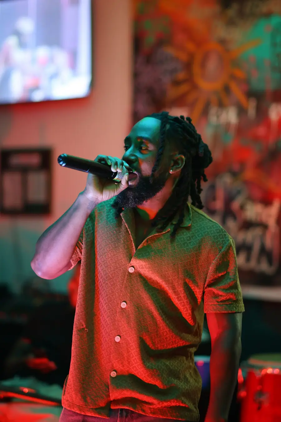 Vocalist with a microphone under warm stage light