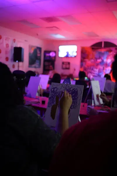A full room painting in pink and red light