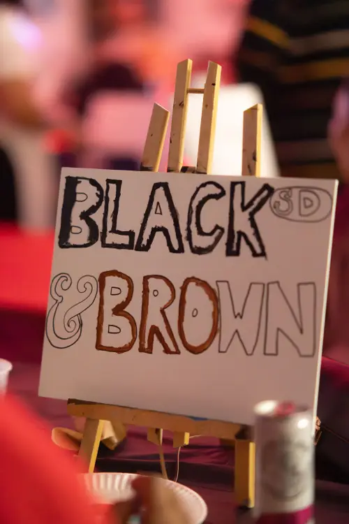Black & Brown hand-lettered canvas on an easel